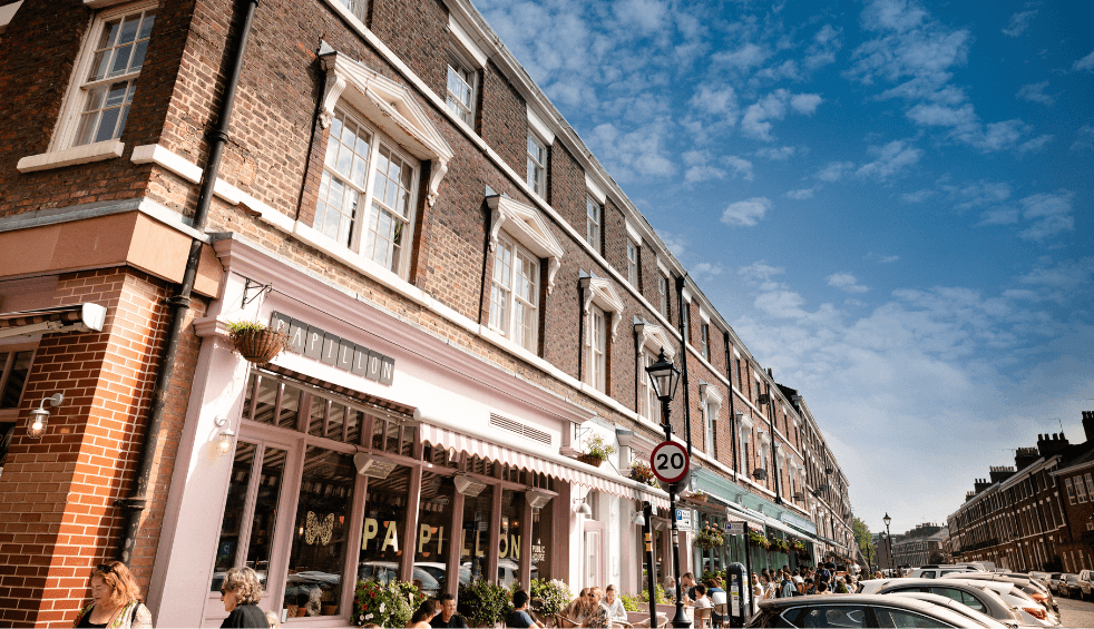 Georgian Townhouses and a baby pink shop front of a cafe with a sign that reads Papillon