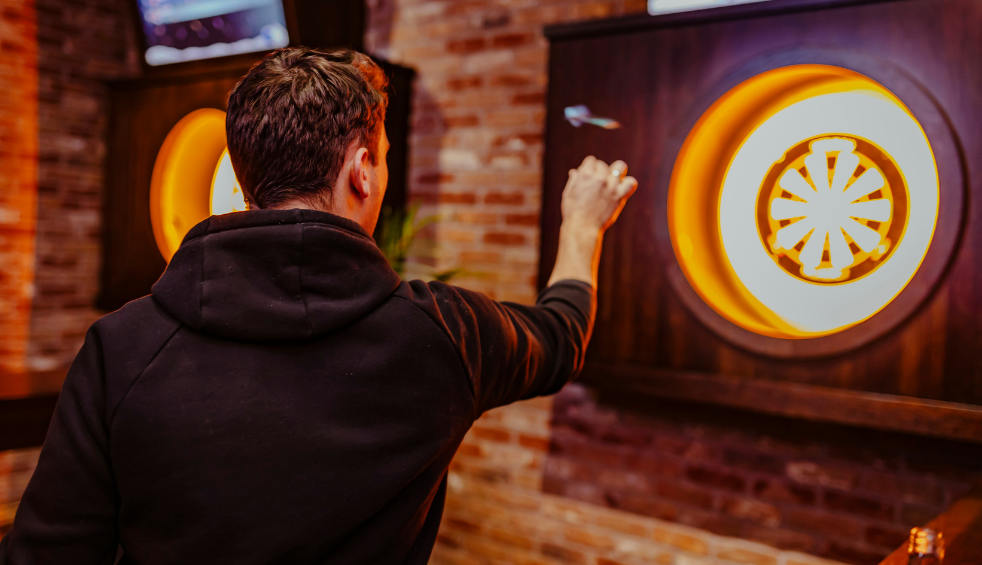 A man playing darts at Roxy Ballroom
