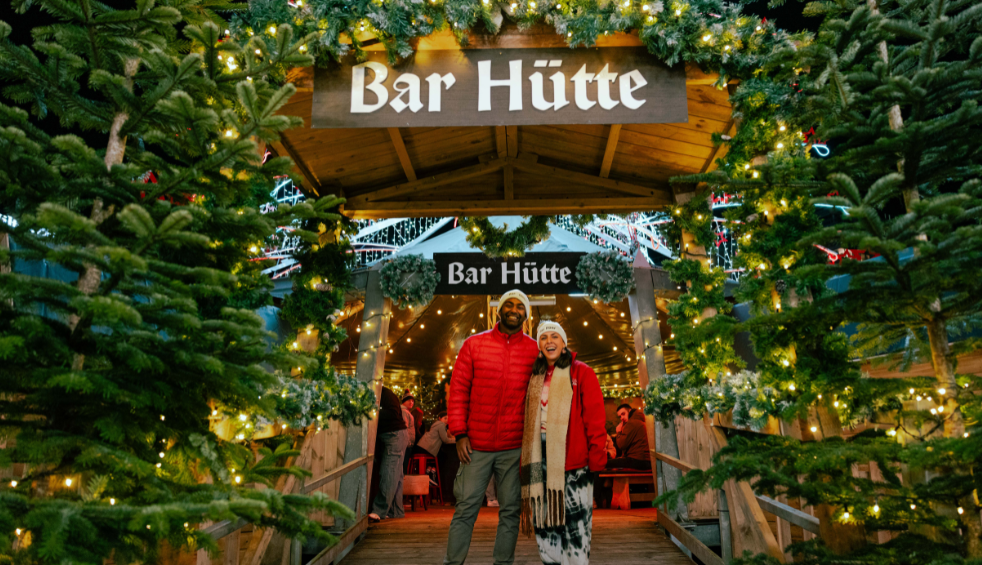 A man and woman stood outide bar hutte