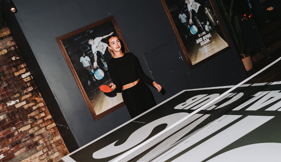 A girl playing table tennis in Pins Social