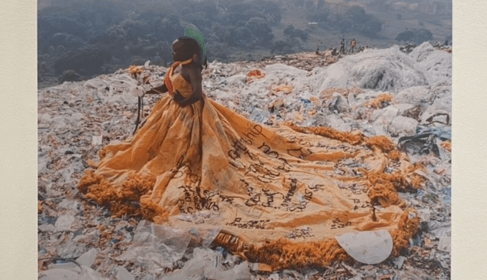 A photograph of a person wearing a large orange dress.