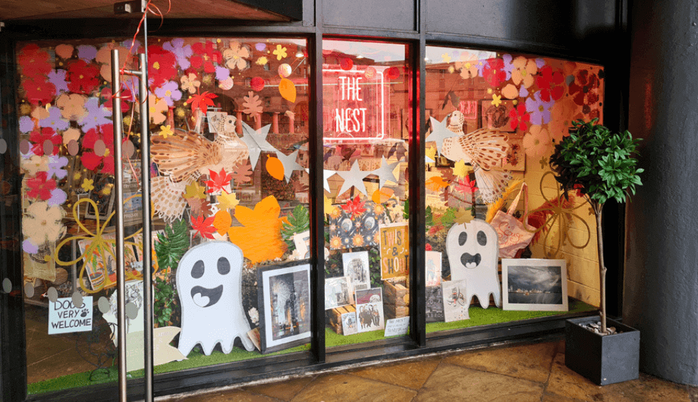 Outside of the shop window with halloween decorations on the window.