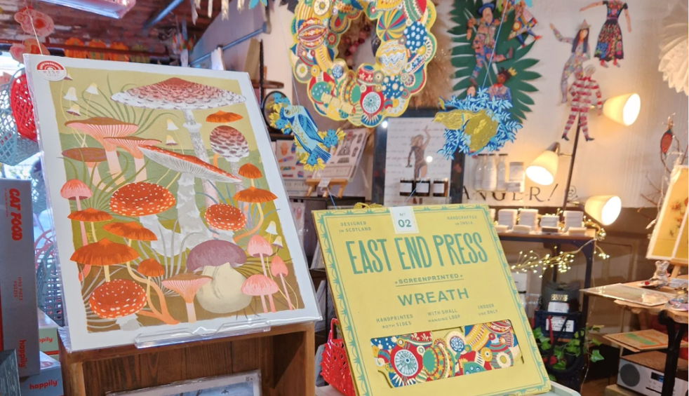 A shop with art works and prints on display for people to buy.