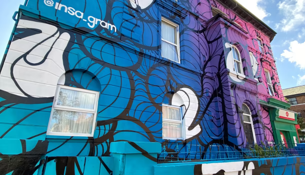 Vibrant blue and purple mural on a building