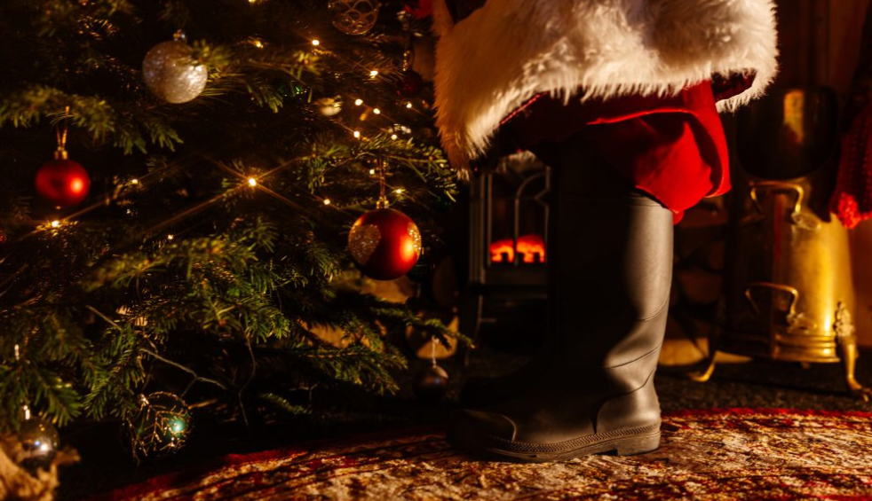 Santas boots by a Christmas tree
