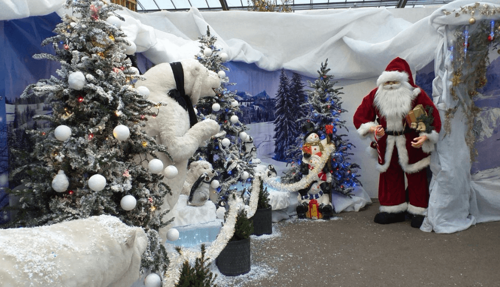 A winter wonderland including a polar bear and Christmas tree