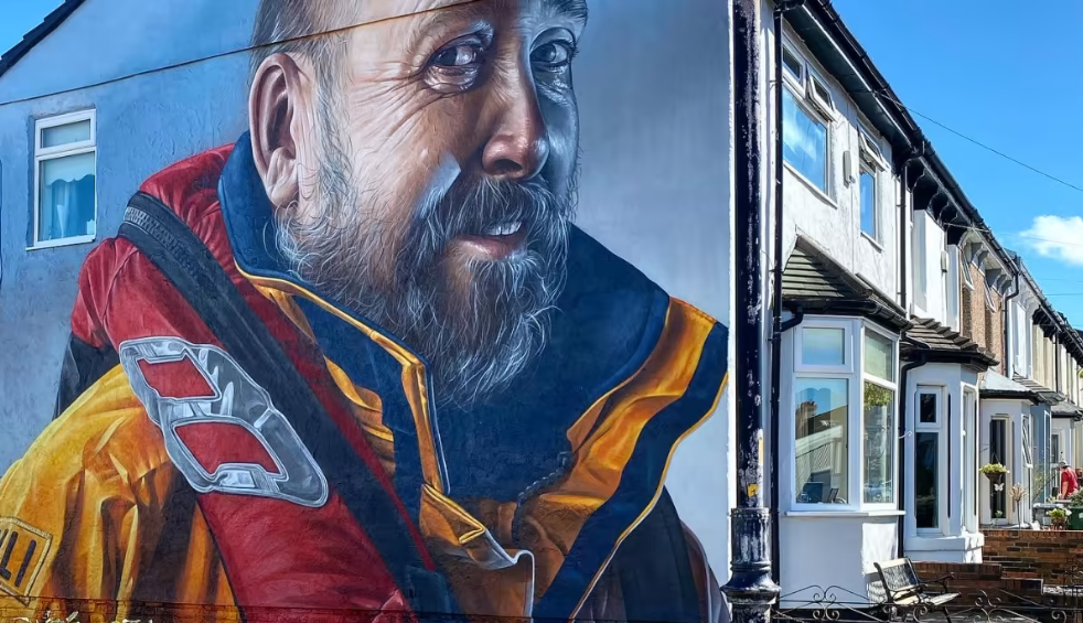 Street art in New Brighton on the side of a house showing a RNLI coastguard