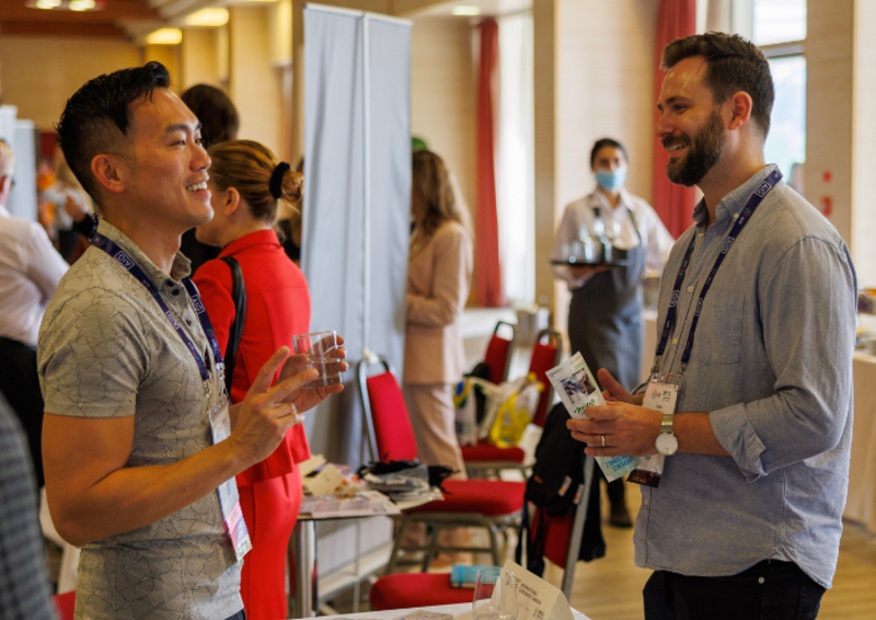 Two people talking while smiling at the expo lunch