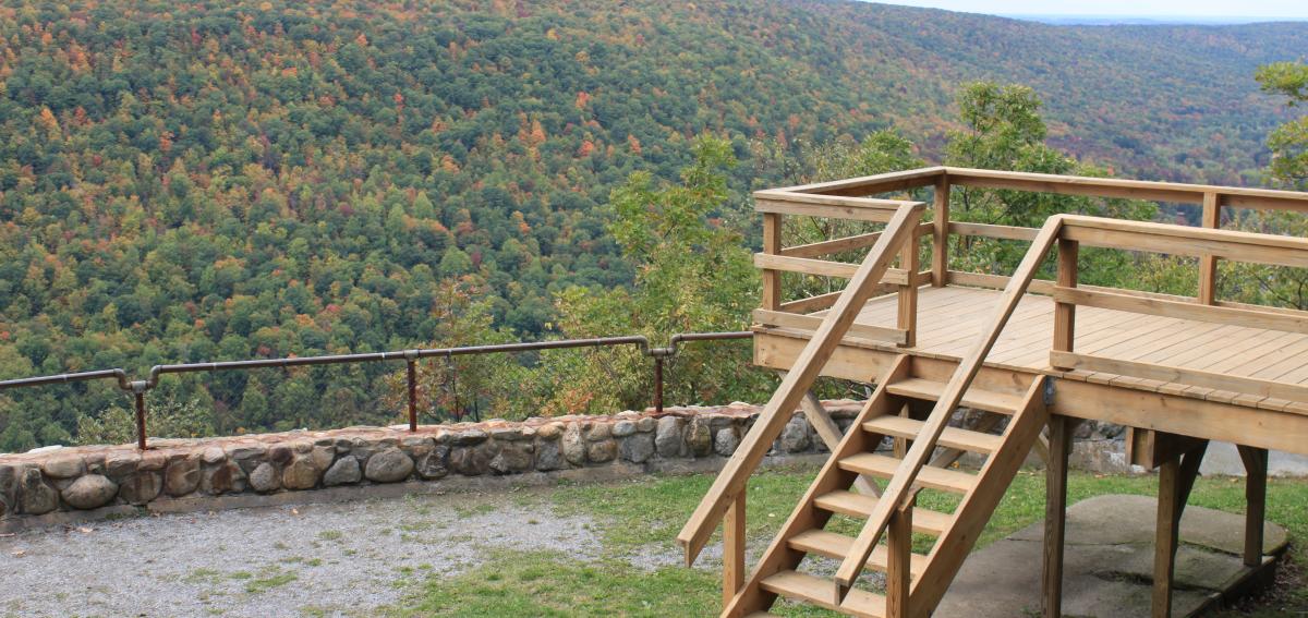 View of Ontario County Parks' "Jump Off", a scenic overlook with views of the surrounding landscape and homes in the distance.