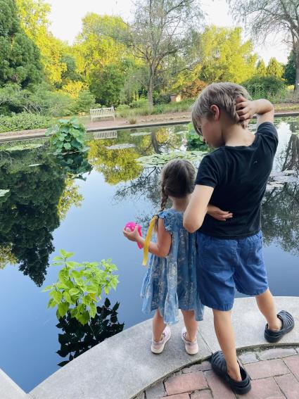 Kids look out at a pond at the Huntsville Botanical Garden.