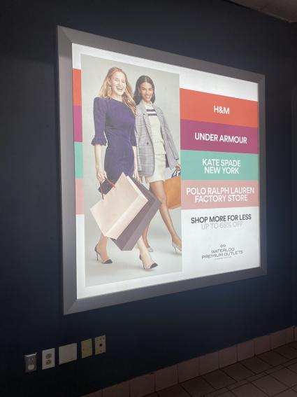 Lit up fashion advertisement with two women and shopping bags