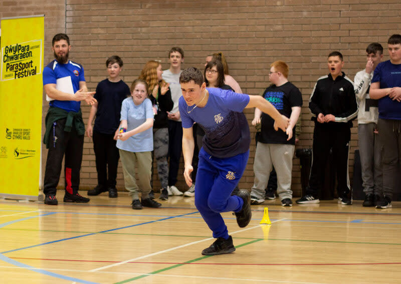 A young man running in a sports hall