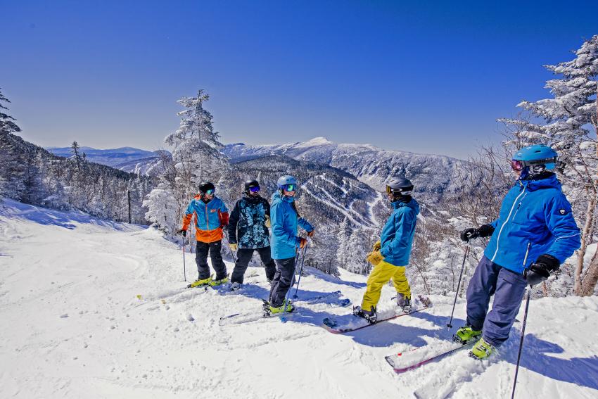 Skiers at Summglers Notch shredding slopes