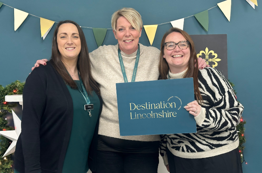 a photo of members of the Destination Lincolnshire team in front of a branded backdrop