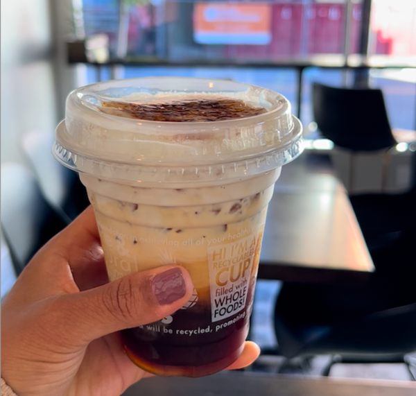 hand holding an iced coffee in a to go cup