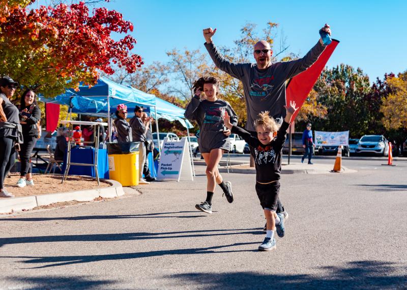 A family runs during the Sugar Skull Fun Run.