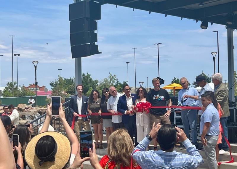 Mayor TimKeller and others stand behind a red ribbon at the grand opening of The Park at Winrock