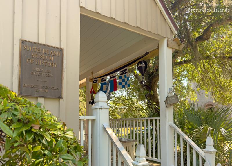 side of a building with a plaque reading Smith Island Museum of History