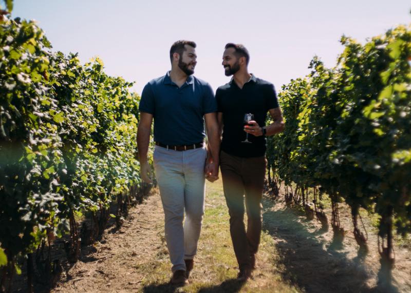 2 men walking through vineyard