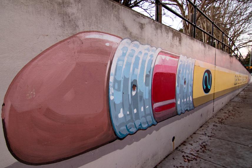 Pencil Mural by artist Michael Brown painted upside down with the words " is mightier than the sword"