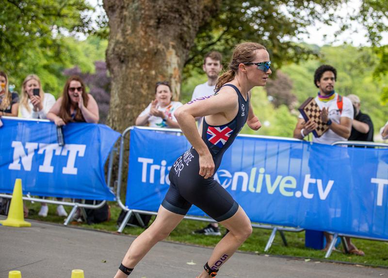 A female para athlete running in a race.