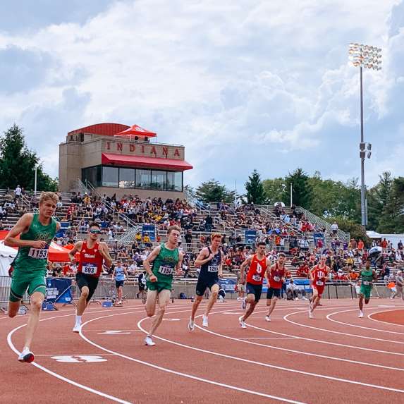 A heat of male runners competing at Bill Armstrong Stadium during a NCAA track and field competition