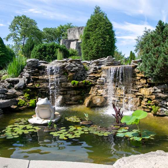A garden pond with limestone rock and sculptures at Oliver Winery