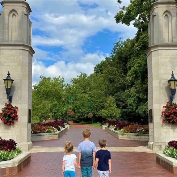 Three small kids holding hands at Sample Gates