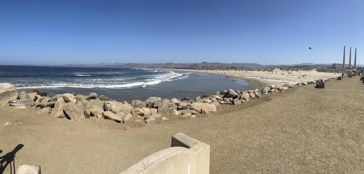 People walking on the Morro Rock Jetty Beach