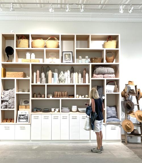 A woman browses in front of shelves at Common Good Co.