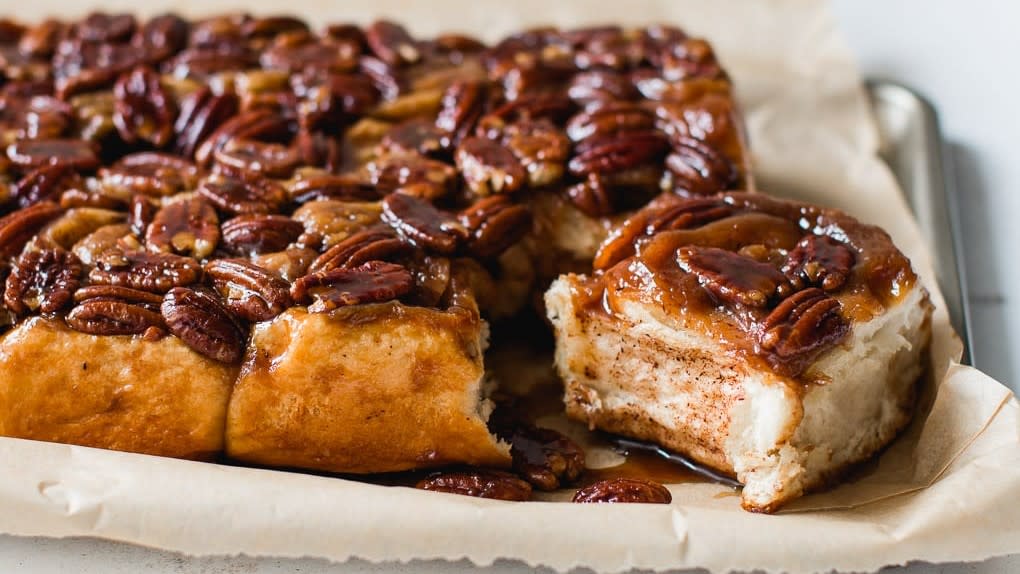 Cinnamon rolls are served with nuts on top at Great Harvest Bread Co.