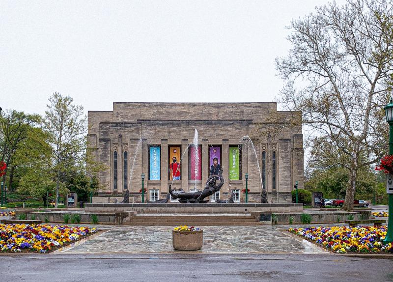 Showalter Fountain surrounded by budding foliage on a rainy spring day