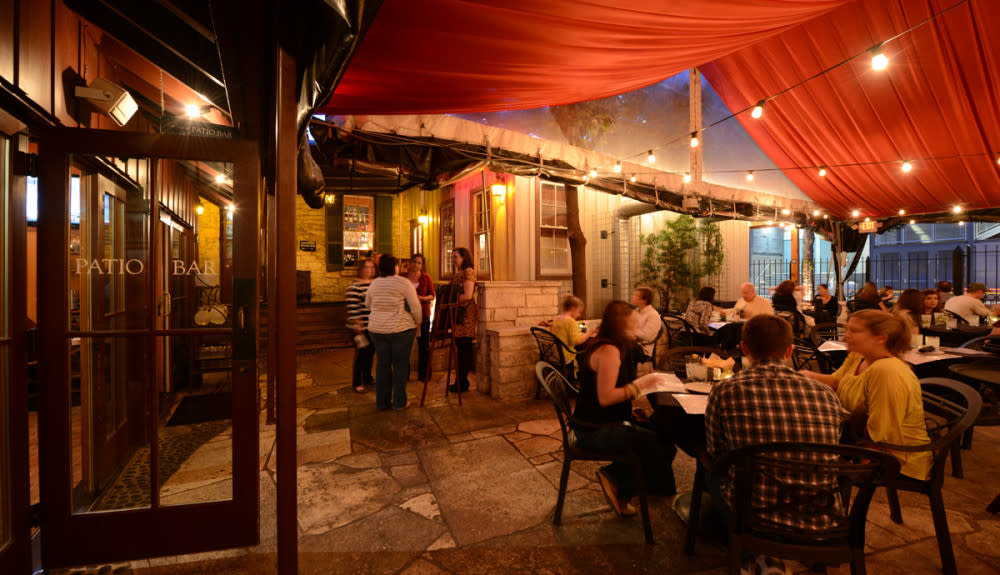 People dining on Moonshine Patio Bar & Grill's patio at night.