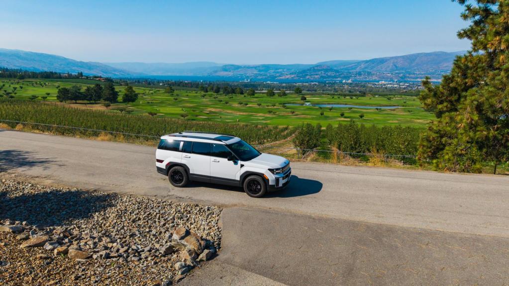 White_SUV_on_Road_Overlooking_Orchards_and_Harvest_Golf_Club_in_Southeast_Kelowna