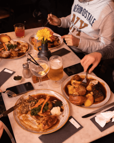 People eating a traditional roast dinner in a pub