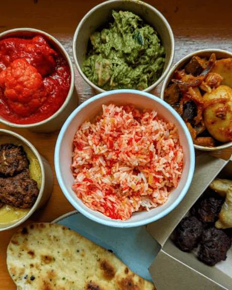 An assortment of bowls of curry style foods