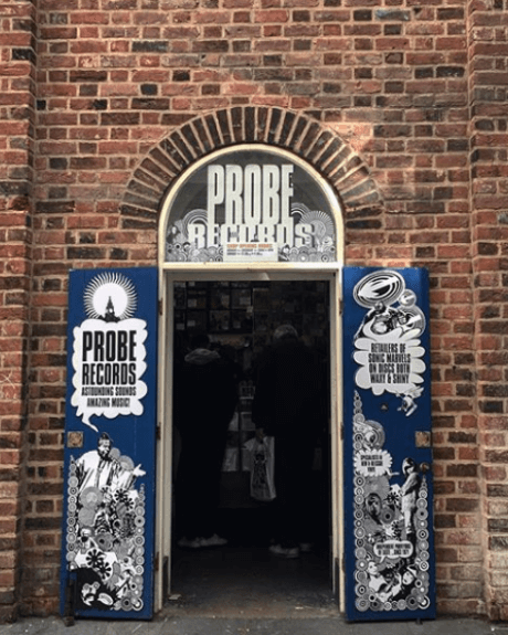 A brick wall with a door in to Probe Records.