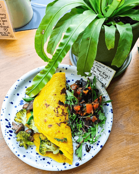 A plate of veggies and a yellow coloured tortilla