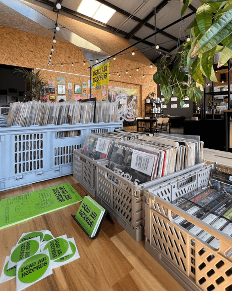 A record store with boxes of records on a table.