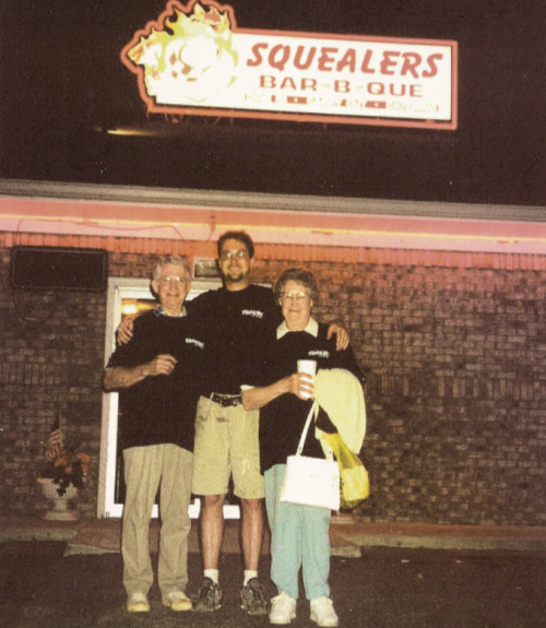 Proud owner Jeff Yater poses with is parents outside the newly opened Squealers Barbeque Grill in the early days in 2001.