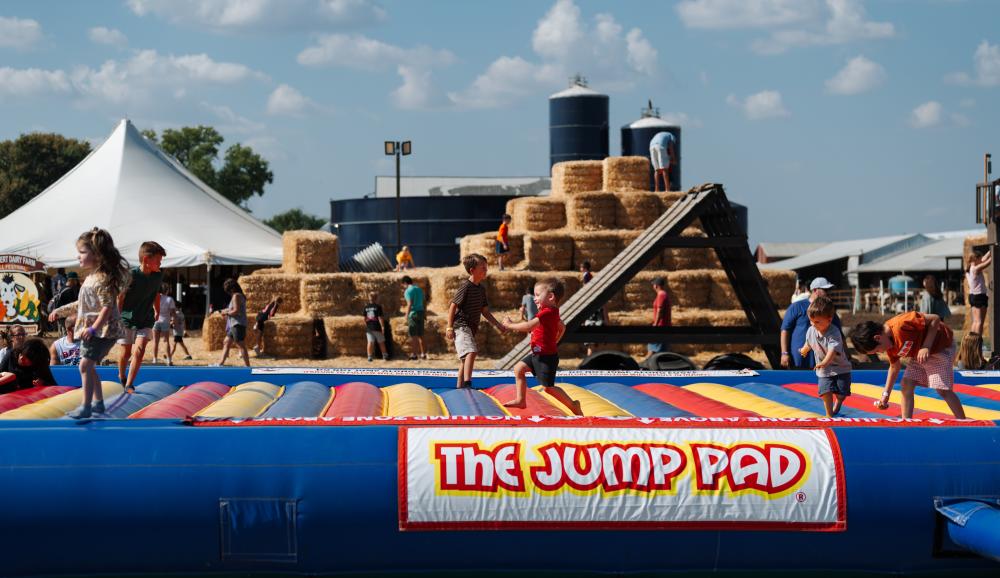 Children enjoying the giant jump pad at the Kuehnert Dairy Fall Festival in Fort Wayne, Indiana.