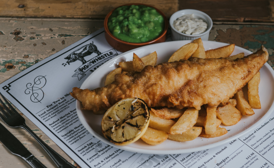Fish & chip meal with additional toppings at The Pig & Whistle Pub