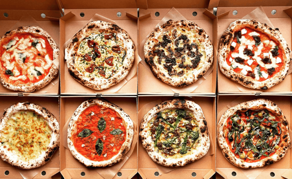a variety of pizzas with different toppings and types of cheese to choose from