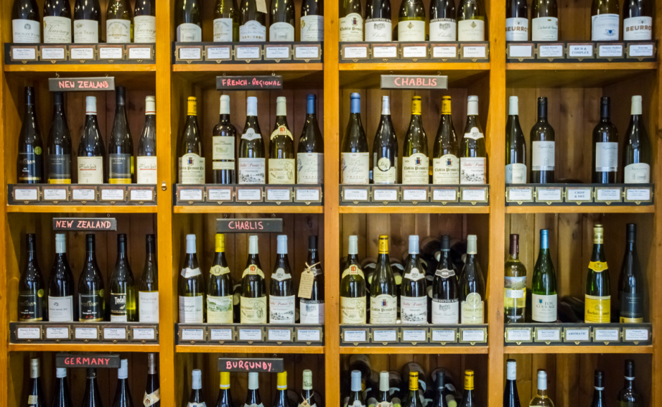 A shelf filled with international wines.