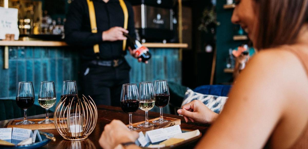 A woman enjoys a drink at a bar