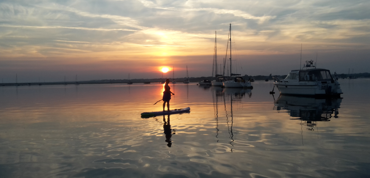 Sunset paddleboarding on the New Forest coast