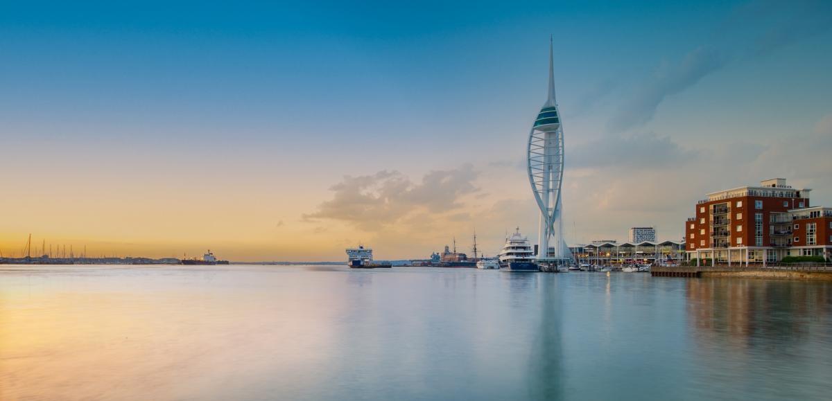 Wide-angle photograph showing Spinnaker Tower and very still waters of Portsmouth Harbour