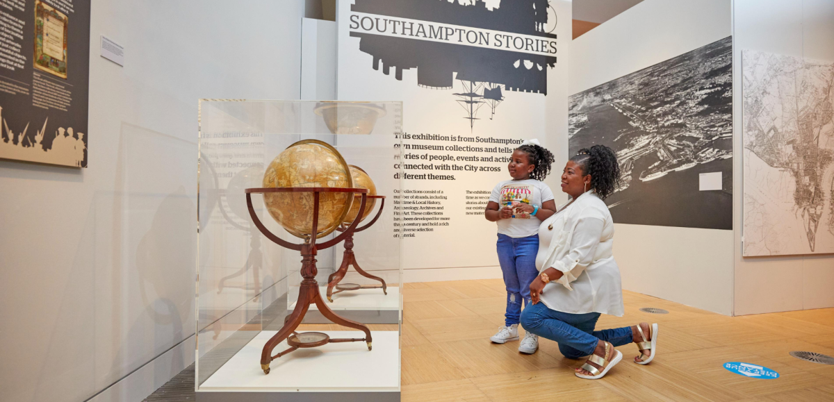 Adult and child looking at globes in Seacity Museum