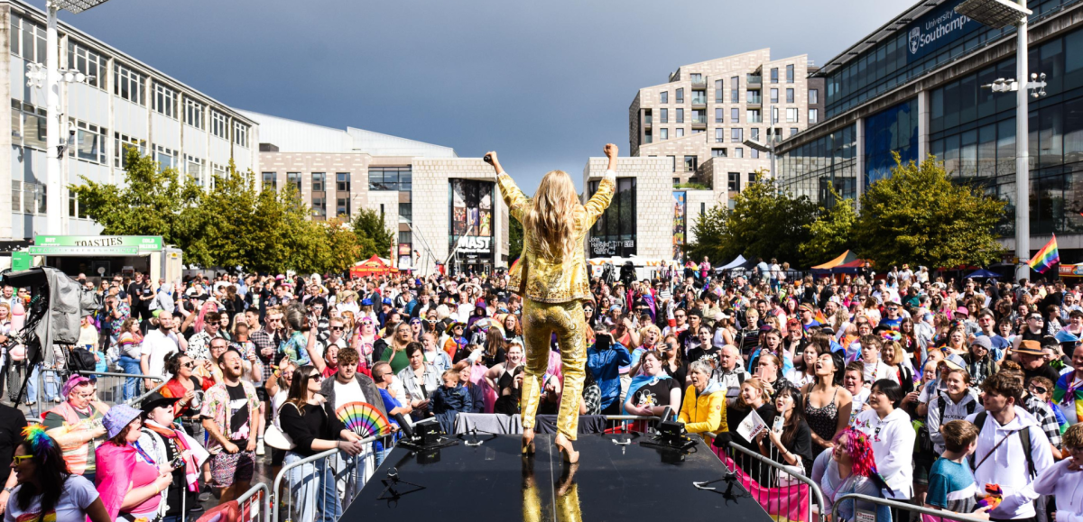 Southampton Pride mainstage with person in a gold suit and crowd