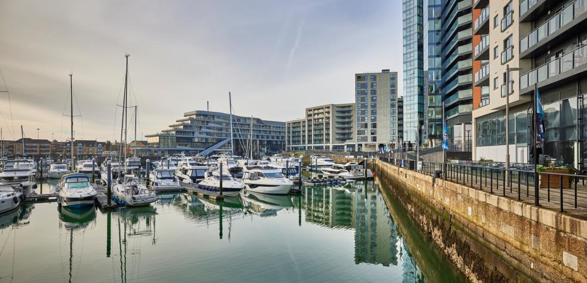 Ocean Village boat moorings at the marina and building reflections in the water